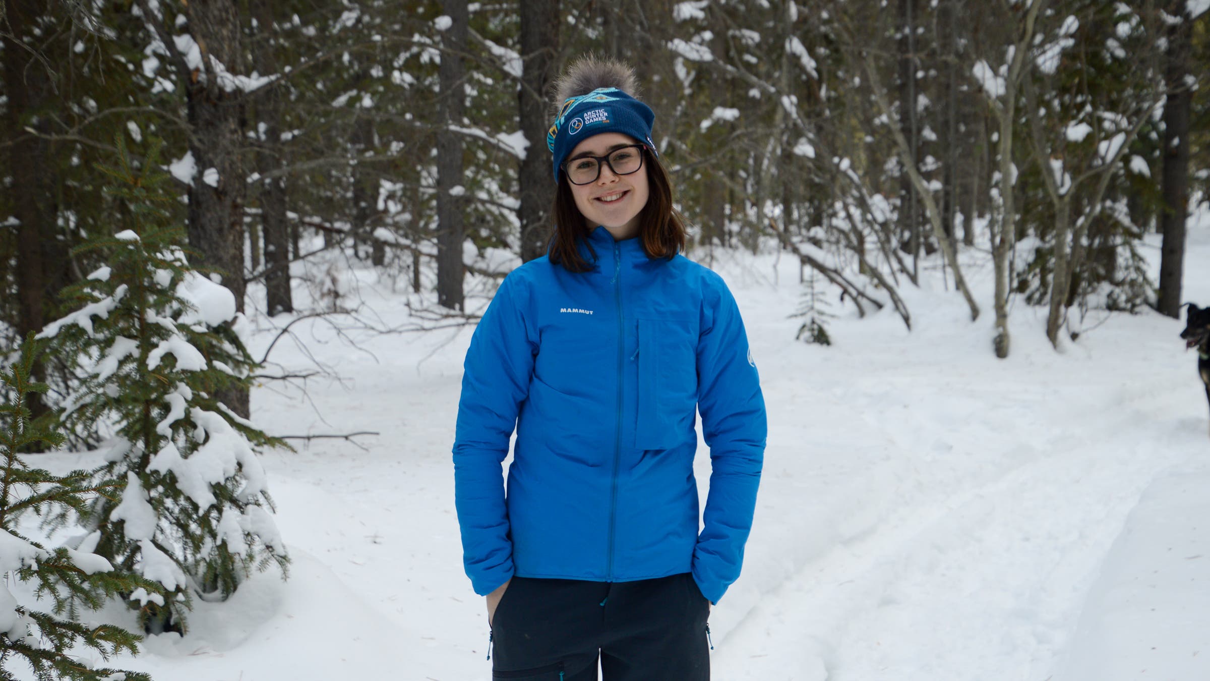 Tester wearing Mammut Ducan Light HS Hooded Jacket in snowy winter forest